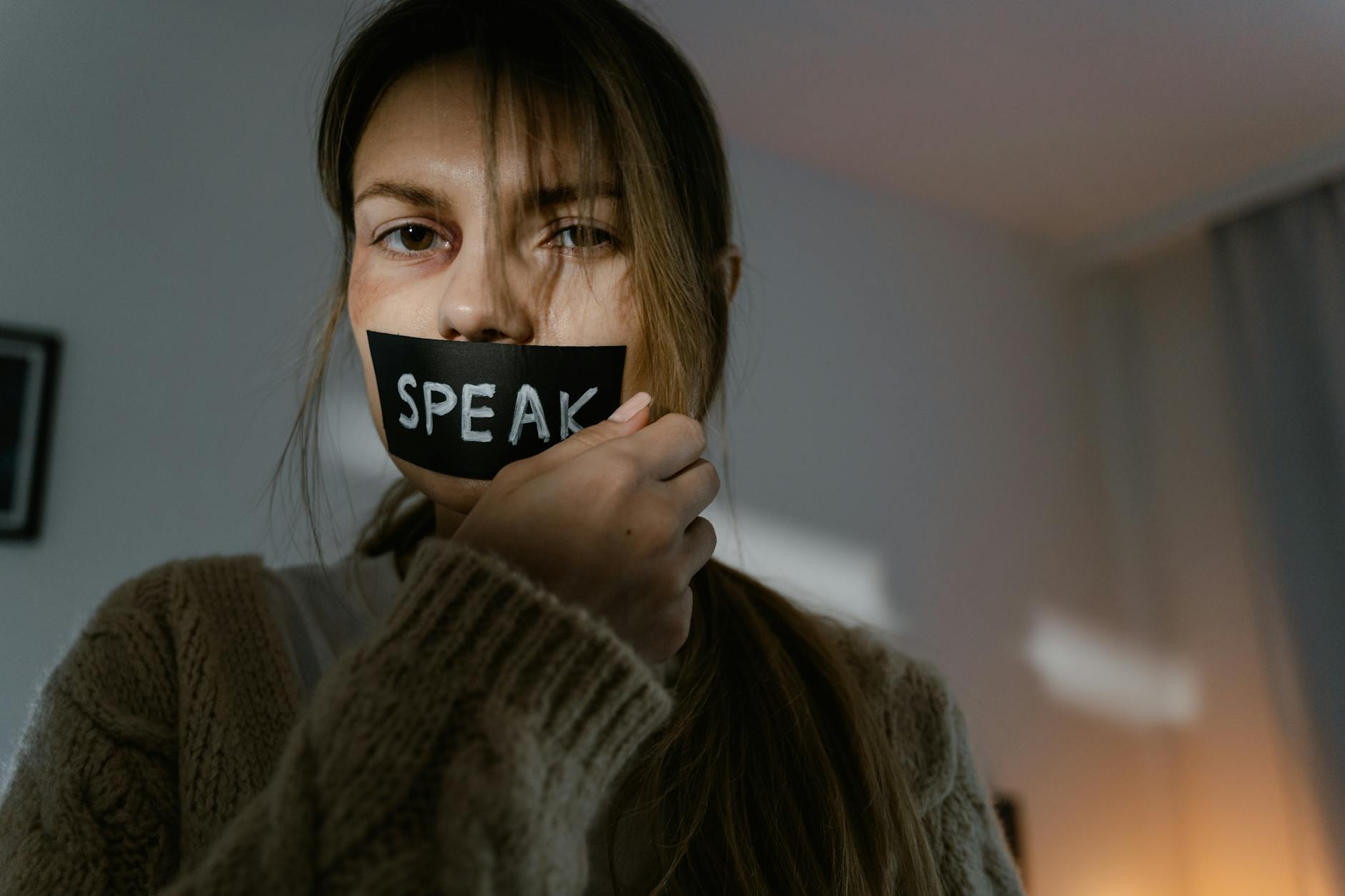 woman holding the black tape on her lips
